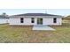 Back view of house with sliding glass door and patio at 10178 Sw 137 Ave, Dunnellon, FL 34432