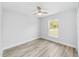 Bright bedroom with wood-look flooring and ceiling fan at 10178 Sw 137 Ave, Dunnellon, FL 34432