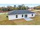 Exterior elevation of a single-story home with gray roof and white siding at 10178 Sw 137 Ave, Dunnellon, FL 34432
