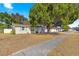 Tan house with green shutters and a sidewalk at 14310 Sw 39Th Court Rd, Ocala, FL 34473