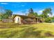 Front exterior of a house with a fenced yard and shrubs by the entrance at 2700 Se 8Th Ave, Ocala, FL 34471