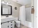 Simple bathroom with a shower/tub combo and white vanity at 2981 Se 140Th Ln, Summerfield, FL 34491