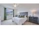 Cozy bedroom with a plush bed, window with green curtains, and gray accents at 4122 Nw 48Th Terrace Rd, Ocala, FL 34482