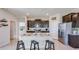 Modern kitchen with dark cabinets, granite countertops, and an island with seating at 4122 Nw 48Th Terrace Rd, Ocala, FL 34482