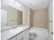 Modern bathroom with a shower/tub combo, white vanity, and neutral tile at 5320 Nw 56Th Ter, Ocala, FL 34482