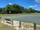 Community basketball court with two hoops, bench, and surrounding trees at 6821 Se 103Rd St, Belleview, FL 34420