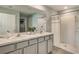 Modern bathroom with dual sinks, shower, and updated vanity at 8465 Las Palmas Way, Wildwood, FL 34785