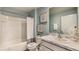 Clean bathroom with a shower/tub combo and marble vanity at 8465 Las Palmas Way, Wildwood, FL 34785
