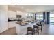 Modern kitchen with granite countertops, stainless steel appliances, and island at 8552 Pinecrest Trl, Wildwood, FL 34785