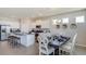 Open concept kitchen and dining area with granite island and table at 8552 Pinecrest Trl, Wildwood, FL 34785