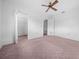 Spacious bedroom with pink carpet, ceiling fan, and closet at 9393 Sw 101St Ln, Ocala, FL 34481