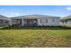 Home's backyard has a screened patio and a large grassy yard at 9781 Sw 79Th Lane Rd, Ocala, FL 34481