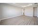 Spacious bedroom with wood-look flooring and access to closet and bathroom at 9781 Sw 79Th Lane Rd, Ocala, FL 34481