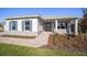 One-story home with gray siding, blue shutters, and a covered porch at 9781 Sw 79Th Lane Rd, Ocala, FL 34481