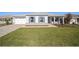 House exterior features a paver driveway and neatly landscaped lawn at 9781 Sw 79Th Lane Rd, Ocala, FL 34481