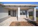 Covered front porch with paver flooring and a stylish front door at 9781 Sw 79Th Lane Rd, Ocala, FL 34481