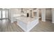 L-shaped kitchen island with white cabinets and stainless steel appliances at 9781 Sw 79Th Lane Rd, Ocala, FL 34481