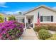 Welcoming front entryway with walkway, landscaping, and American flag at 13746 Se 88Th Ave, Summerfield, FL 34491