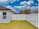 Fenced backyard with a gate and solar panels on a nearby roof at 15720 Sw 19Th Ter, Ocala, FL 34473