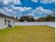 Spacious backyard with a white fence, patio furniture, and lush lawn at 15720 Sw 19Th Ter, Ocala, FL 34473