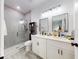 Modern bathroom with double vanity, glass shower, and gray tile at 15720 Sw 19Th Ter, Ocala, FL 34473