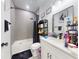 Modern bathroom with a shower/tub combo, white vanity, and gray tile at 15720 Sw 19Th Ter, Ocala, FL 34473