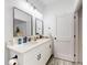 Modern bathroom with white vanity, dual sinks, and contemporary lighting at 15720 Sw 19Th Ter, Ocala, FL 34473