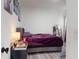 Bedroom with a purple bed, nightstand, and wall art at 15720 Sw 19Th Ter, Ocala, FL 34473