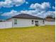 Back exterior of a single-story home with a fenced backyard and patio at 15720 Sw 19Th Ter, Ocala, FL 34473