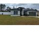 One-story home with gray siding, black shutters, and a two-car garage at 15720 Sw 19Th Ter, Ocala, FL 34473