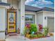Welcoming front entrance with a stylish yellow door, lush landscaping, and decorative accents at 15720 Sw 19Th Ter, Ocala, FL 34473