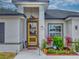Inviting front yard with a yellow door, decorative plants, and a welcoming atmosphere at 15720 Sw 19Th Ter, Ocala, FL 34473