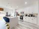 Bright and airy kitchen featuring white cabinetry, an island with seating, and sleek appliances at 15720 Sw 19Th Ter, Ocala, FL 34473