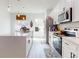 Modern white kitchen with stainless steel appliances, large island, and ample counter space at 15720 Sw 19Th Ter, Ocala, FL 34473
