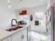 Bright kitchen featuring white cabinets, quartz countertops, and a farmhouse sink at 15720 Sw 19Th Ter, Ocala, FL 34473