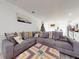 Comfortable and spacious living room with a large sectional sofa and view of the adjacent kitchen at 15720 Sw 19Th Ter, Ocala, FL 34473