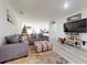 Inviting living area featuring a large sectional sofa, decorative rug, and entertainment center at 15720 Sw 19Th Ter, Ocala, FL 34473
