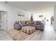Open-concept living room with a sectional sofa, ottoman, and view of the kitchen and dining area at 15720 Sw 19Th Ter, Ocala, FL 34473
