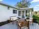 Relaxing patio with wooden furniture and lush greenery at 17973 Se 104Th Ter, Summerfield, FL 34491