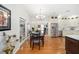 Dining area with round wooden table and chairs overlooking the living room at 2023 Se Laurel Run Dr, Ocala, FL 34471