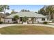 One-story home with green tile roof and landscaping at 2023 Se Laurel Run Dr, Ocala, FL 34471