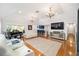 Living area with white furniture, a grand piano, and a wet bar at 2023 Se Laurel Run Dr, Ocala, FL 34471