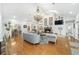 Living room with vaulted ceilings, chandelier, fireplace, and view to the dining area at 2023 Se Laurel Run Dr, Ocala, FL 34471