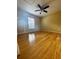 Bedroom with polished wood floors and ceiling fan at 3 Redwood Run Radl, Ocala, FL 34472