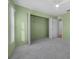 Light green bedroom with grey carpet and closet at 4367 Se 106Th Pl, Belleview, FL 34420