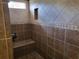 Walk-in shower with tile walls, a built-in seat, and a window at 444 Ne 63Rd St, Ocala, FL 34479