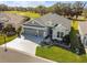 Single-story home with gray exterior, two-car garage, and landscaped yard at 4522 Shockoe Cir, The Villages, FL 32163