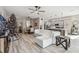 Open living room with white sectional sofa and Christmas tree at 4522 Shockoe Cir, The Villages, FL 32163