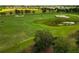 Lush green golf course with water features and golf carts at 5268 Nw 46Th Lane Rd, Ocala, FL 34482