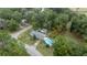 An aerial view of a property with a pool, shed, and surrounding trees at 6780 Nw 60Th St, Ocala, FL 34482